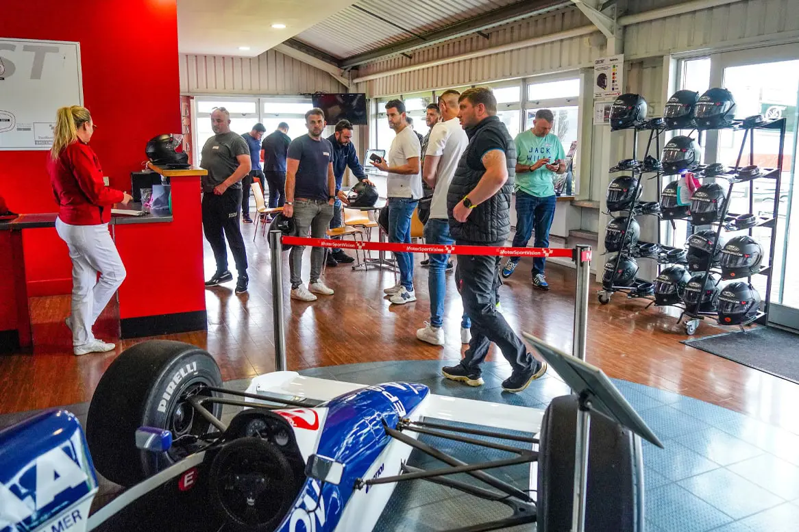 Guests getting ready for their day out on track, helmets feature behind