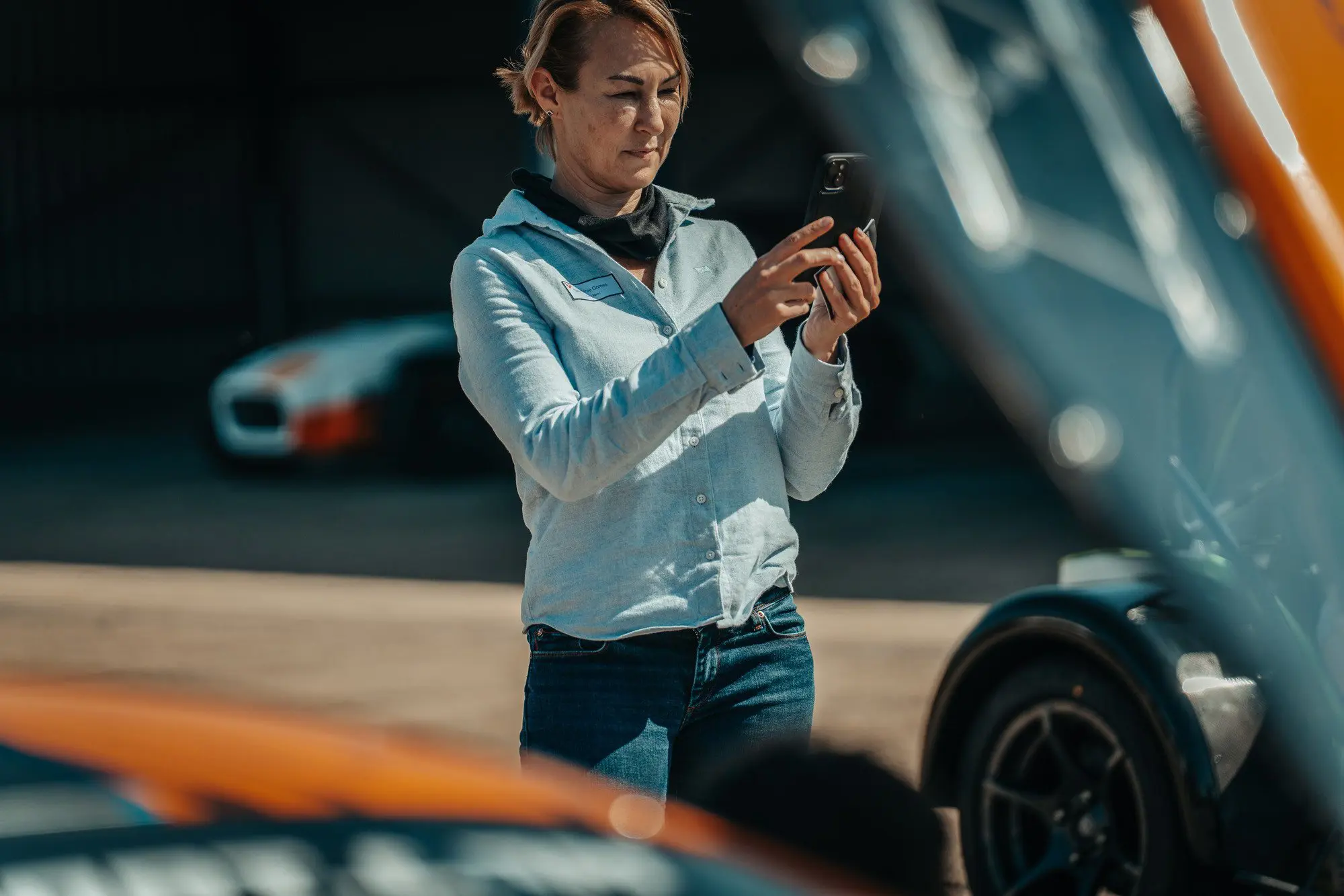 Lady taking photo of McLaren Artura GT4