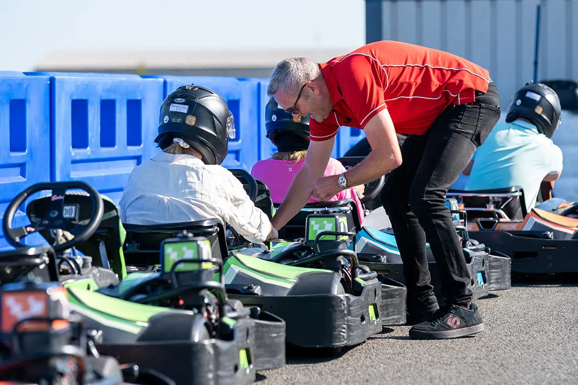 Instructor talking to guests in Sodi GT5 Karts