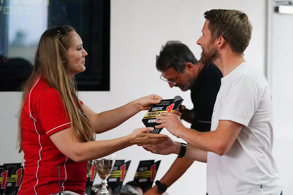 Female instructor haning out prizes to guests