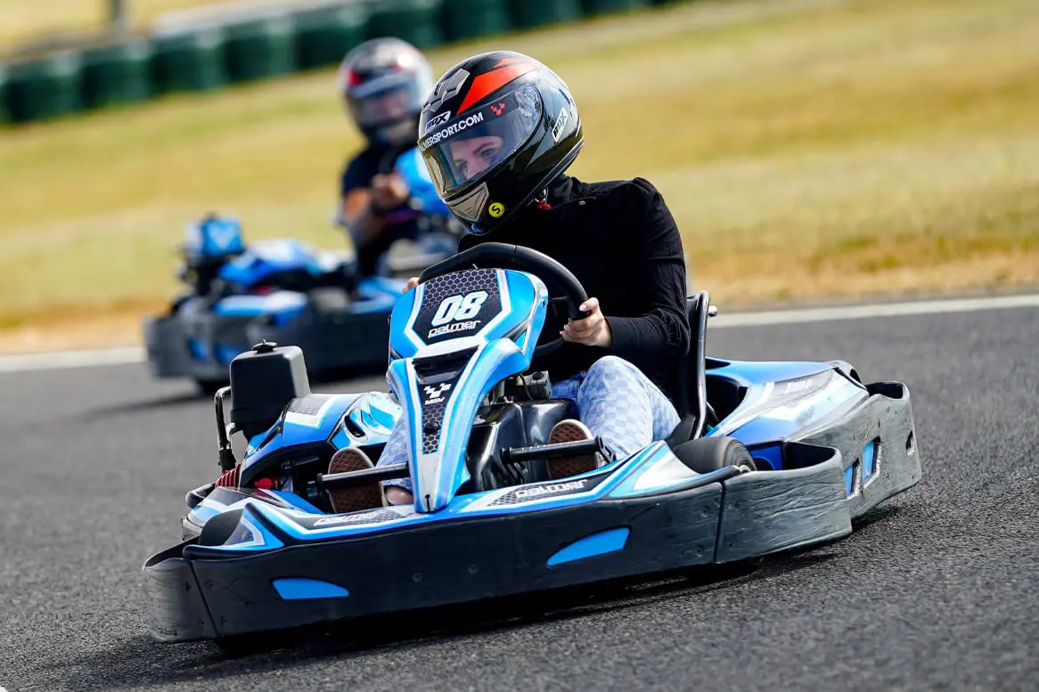 2 people driving the Sodi GT5 Karts
