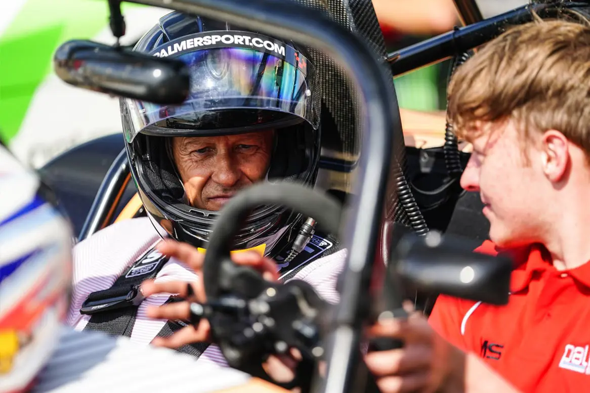 Instructor talking to guest in helmet in the Catherham PalmerSport