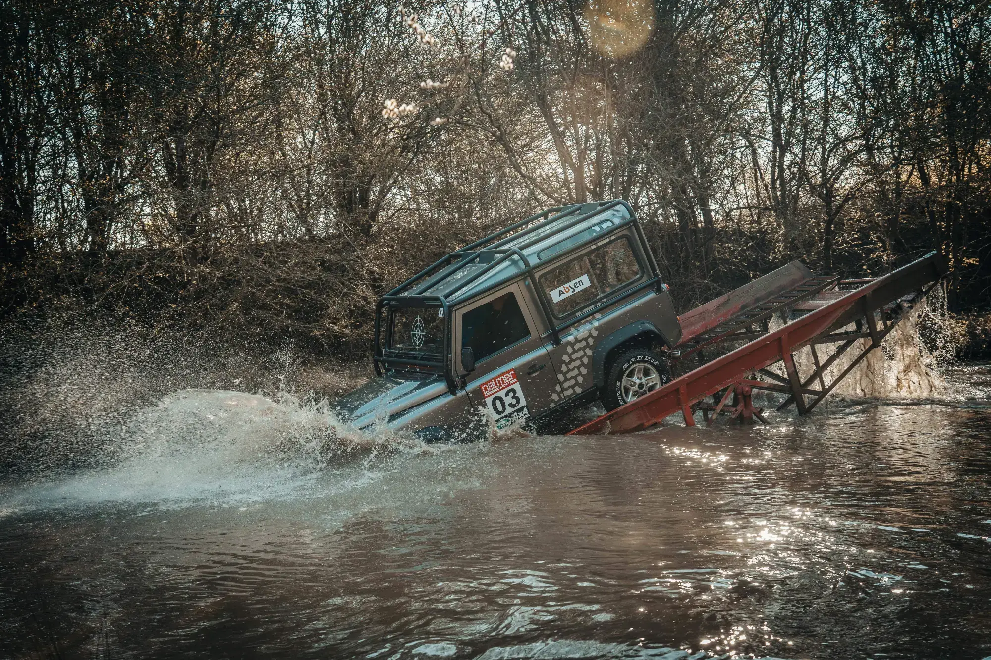 Land Rover splashing into the water obstacle