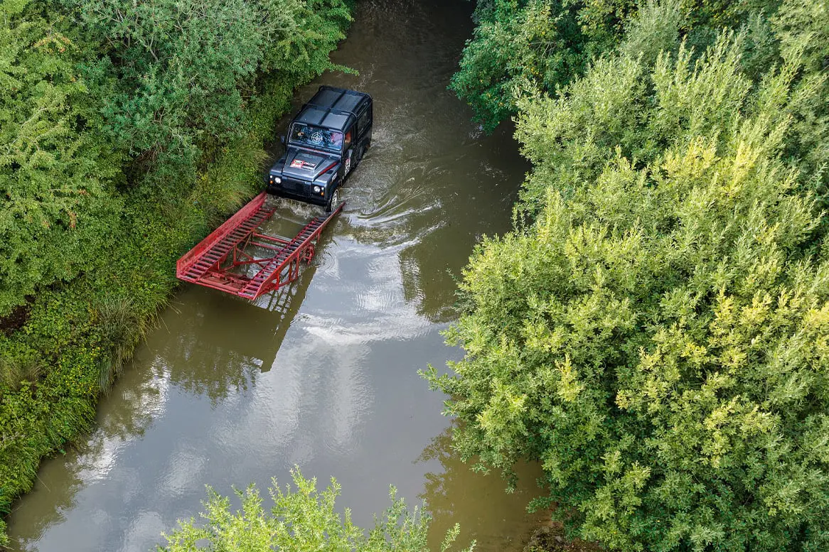 Land Rover in water about to go on ramp